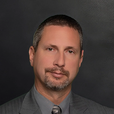Chiropractor Jason Mackey In Suit And Tie Smiling